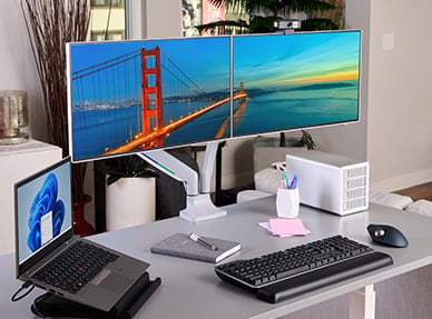 Modern home office desk set up with Kensington devices on it.