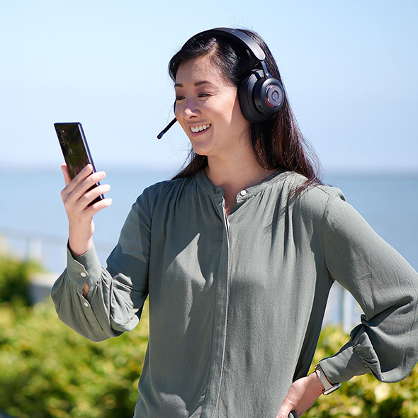 Woman calling from her phone and H3000 headset.