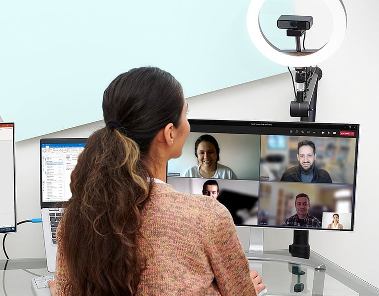 Woman on a virtual meeting using a Kensington web camera and ring light