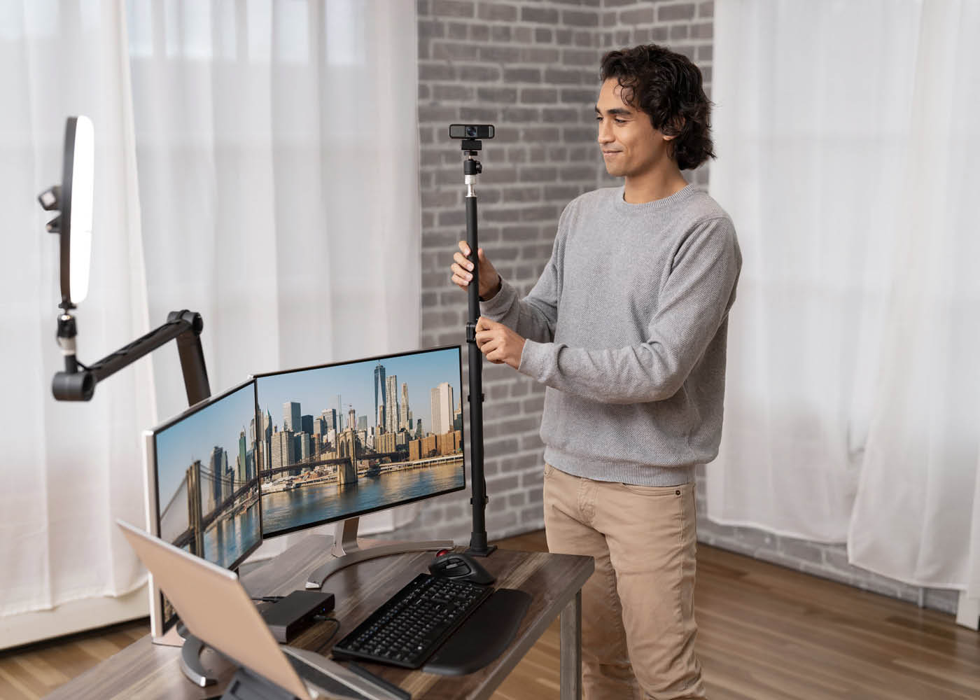 Man setting up Kensington W2050 Webcam for a remote office