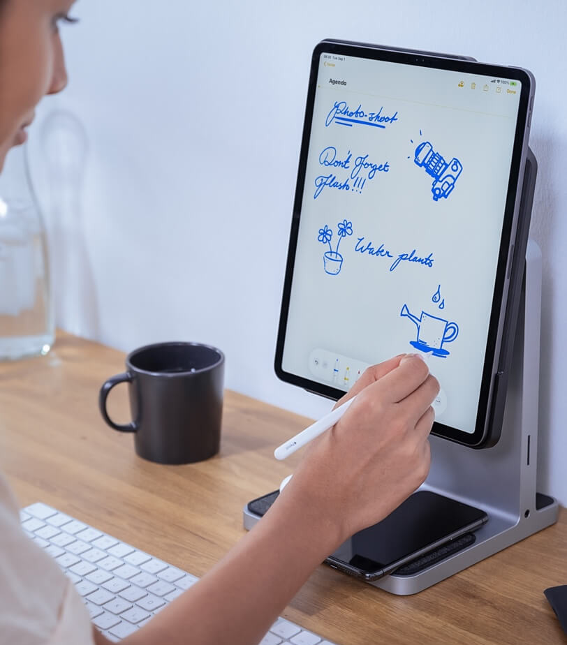 Woman using an Apple Pencil with an iPad and the Kensington StudioDock in the vertical position