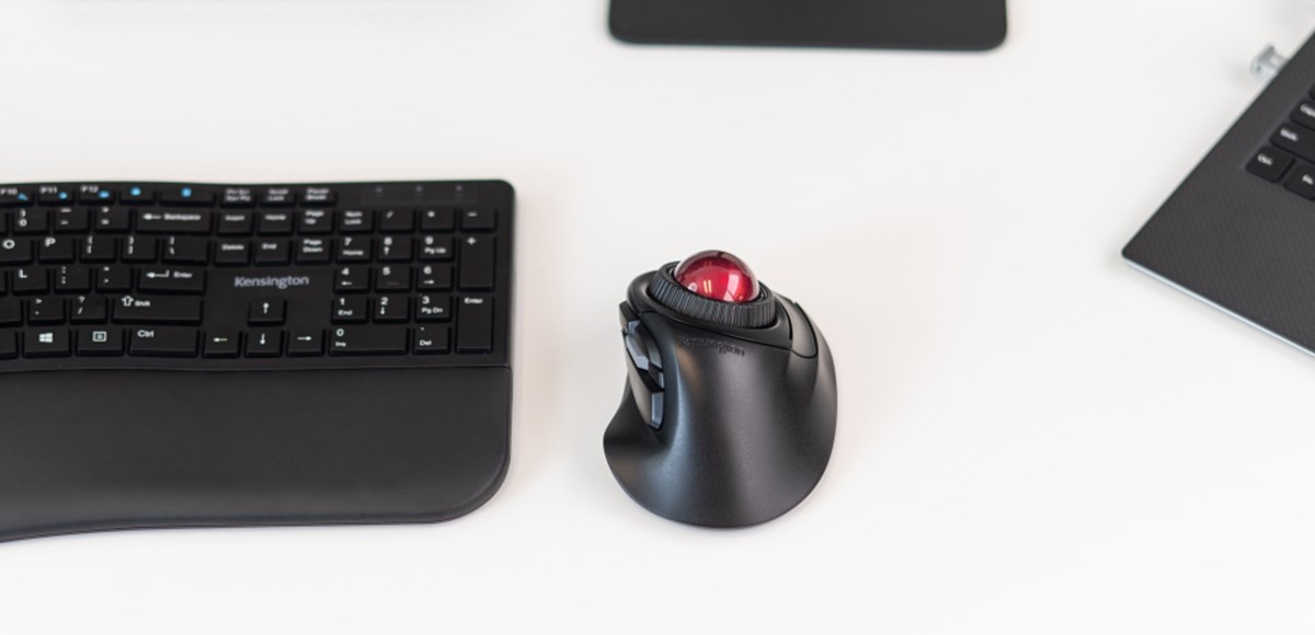 Close up shot of a Kensington Orbit Fusion wireless Trackball on a white desk