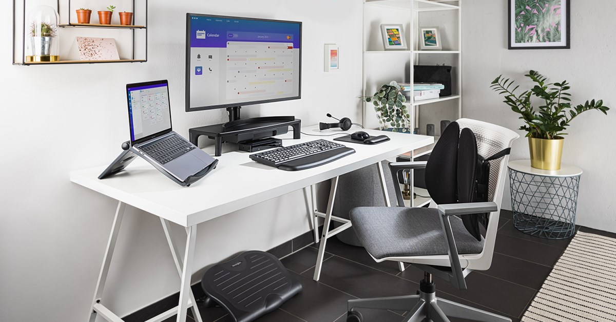 White desk equipped with a laptop on a Kensington laptop riser