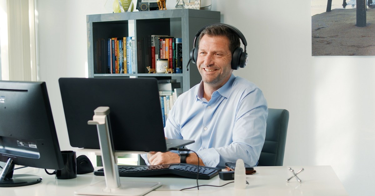 An executive using the H3000 headset and Kensington universal audio switch