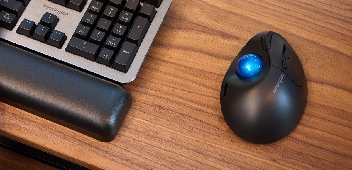 Pro Fit Ergo TB450 Kensington Trackball on a wooden desk.