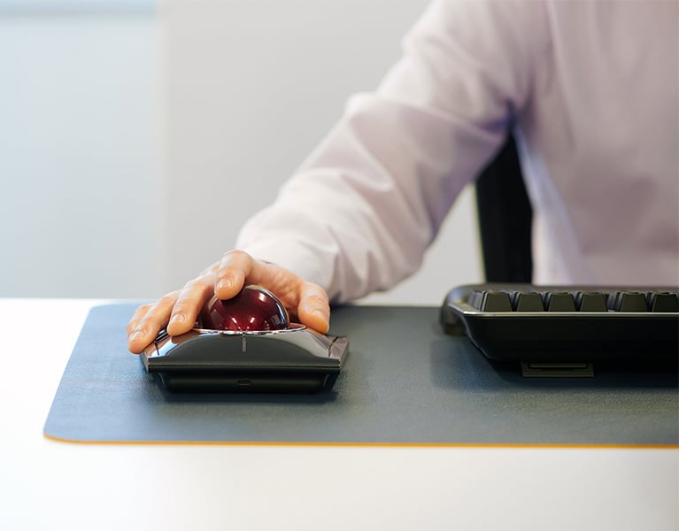 Closeup of man using a Kensington Expert Mouse Wireless Trackball