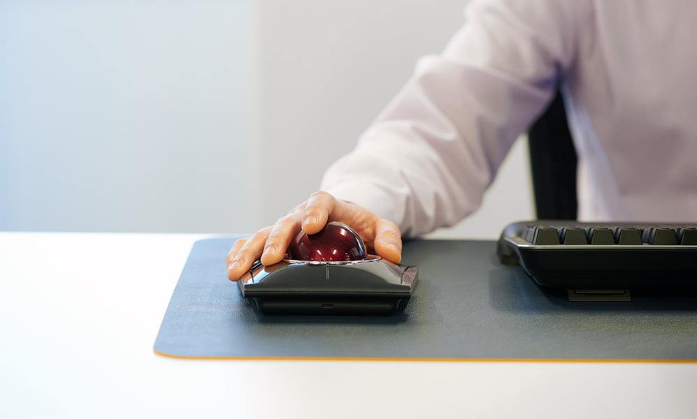 Closeup of man using a Kensington Expert Mouse Wireless Trackball