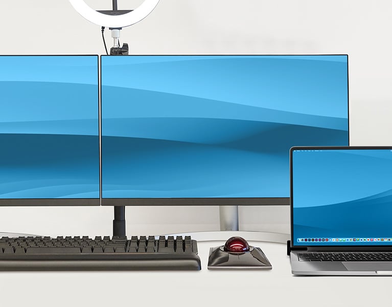 Macbook yhdistettynä useisiin Kensigton-laitteisiin ja kahteen näyttöön.
