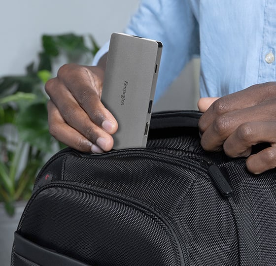 Close  up of a professional packing the Kensington UH1400P USB®C 8-in1 Driverless Mobile Hub into a Kensington backpack.