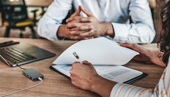 two businessmen looking at business documents, ready to sign a contract. 