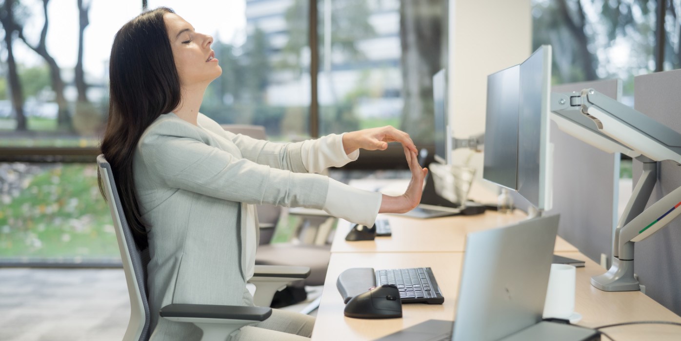 Woman stretching at desk