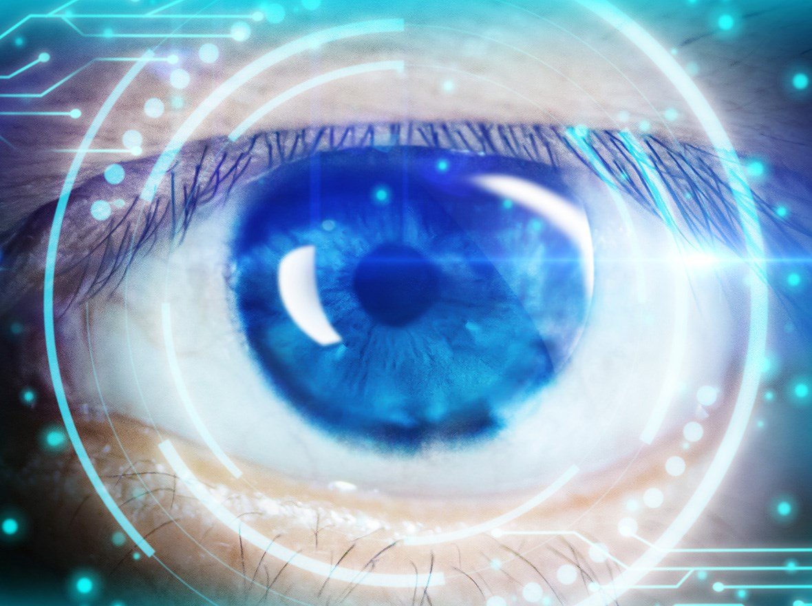 Up-close of eye reflecting the use of technology.
