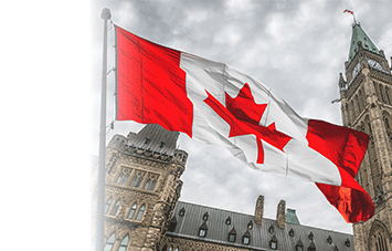 Canadian flag waving in front of Parliament Buildings in Ottawa.