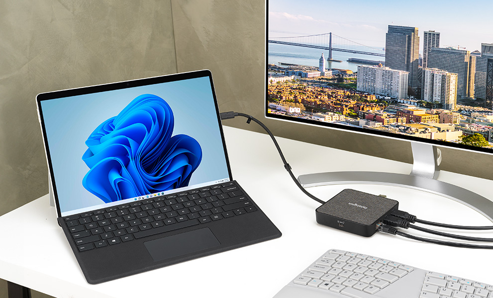 Laptop connected to several devices thanks to a kensington dock designed for microsoft surface.