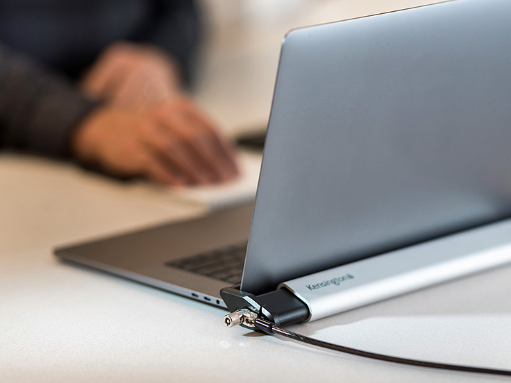 Kensington laptop lock securing a laptop on a desk