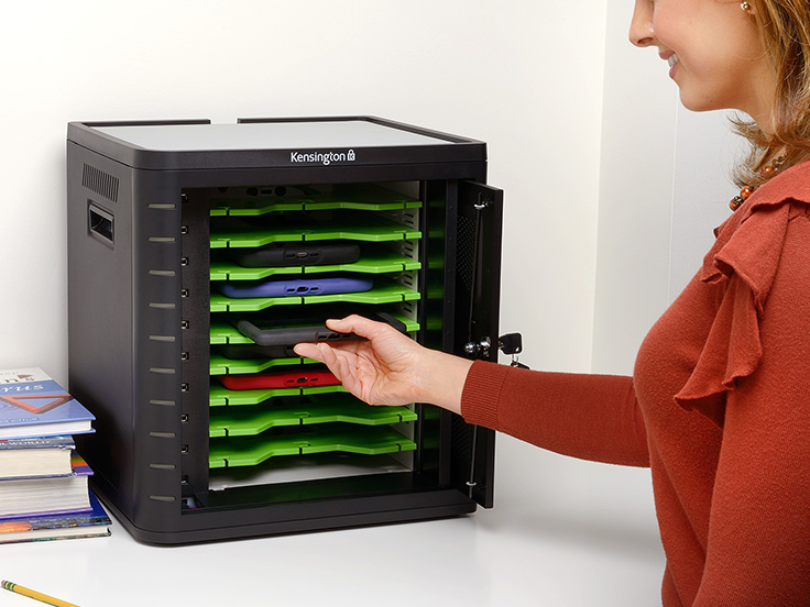 Woman placing a tablet into a Kensington cabinet