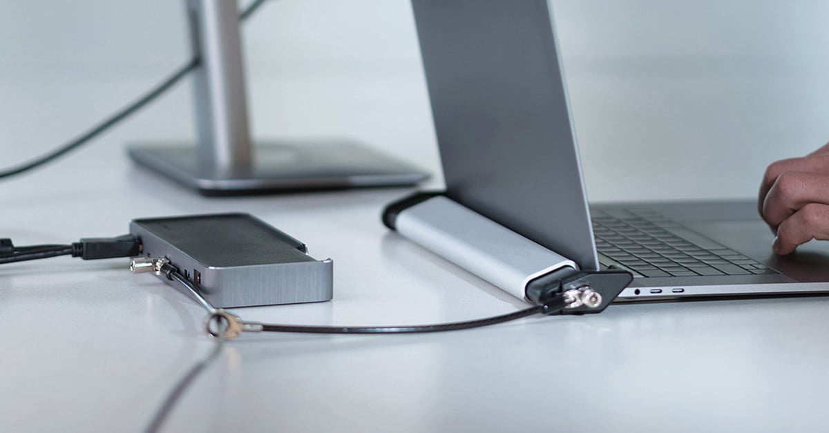 Kensington docking station connected to a laptop lock securing a laptop