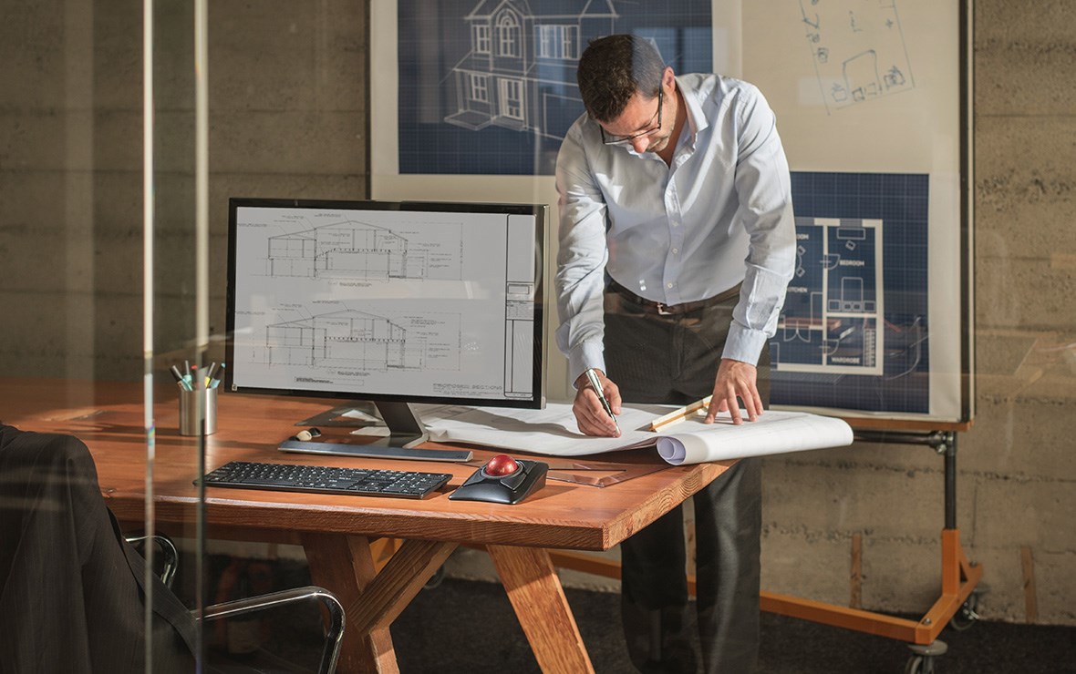 Man working on a project using the precision control of his Expert Trackball.