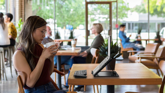 Woman working from coffee shop with Kensingtonp products